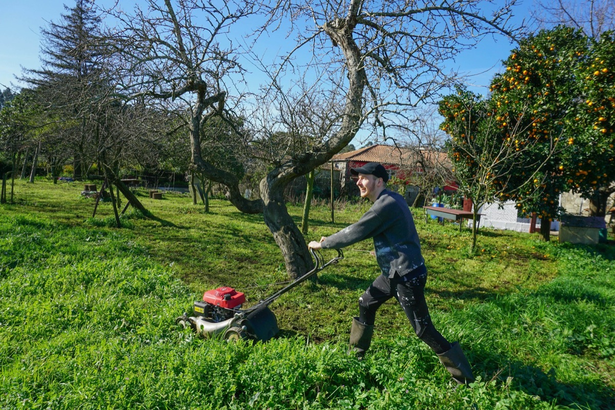 Commercial operator mowing a large lawn