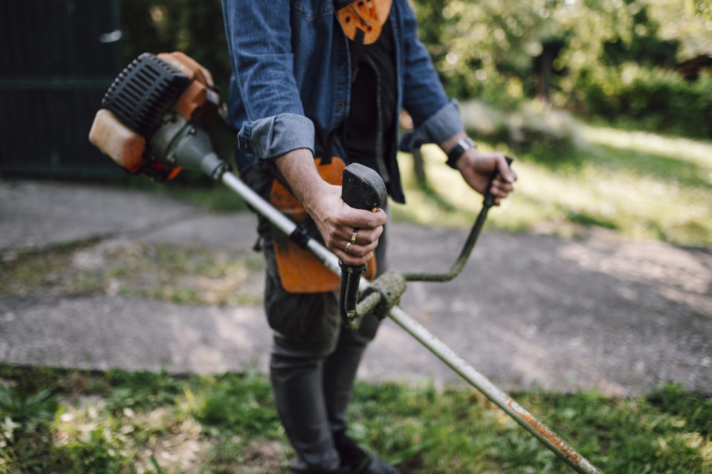 Person using a string trimmer in a garden